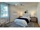 Cozy bedroom featuring a queen-sized bed, neutral tones, stylish decor, and natural light from a window at 9190 Oakdale Ranch Ct, Las Vegas, NV 89139
