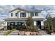 Two-story home with a neutral color scheme, dark shutters, stone accents, and manicured landscaping at 9190 Oakdale Ranch Ct, Las Vegas, NV 89139