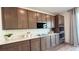 Kitchen featuring white countertops, custom cabinets, stainless steel microwave and double oven at 9190 Oakdale Ranch Ct, Las Vegas, NV 89139