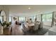 Open-concept living area showcasing a modern dining table, comfortable living space, and hardwood floors at 9190 Oakdale Ranch Ct, Las Vegas, NV 89139