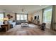 Cozy living room featuring neutral colors, hardwood floors, modern furniture, and large windows at 9190 Oakdale Ranch Ct, Las Vegas, NV 89139