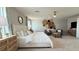 Tranquil main bedroom with neutral tones, decorative wall art, soft textures, and a comfortable seating area at 9190 Oakdale Ranch Ct, Las Vegas, NV 89139