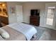 Bedroom featuring a dresser with TV, carpeted floors, neutral walls, and access to an outdoor balcony at , Las Vegas, NV 89148