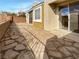Backyard featuring a stone patio and sliding glass door access to the home at 1001 Collingtree St, Las Vegas, NV 89145