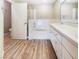 Bright bathroom featuring a soaking tub, glass-enclosed shower, and dual sink vanity at 1001 Collingtree St, Las Vegas, NV 89145