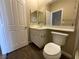 Neutral-toned bathroom with a toilet and vanity; features a white door and modern fixtures at 1001 Collingtree St, Las Vegas, NV 89145