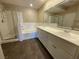 Bright bathroom featuring a shower, bathtub, and double vanity sink with wood-look flooring at 1001 Collingtree St, Las Vegas, NV 89145