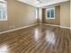 Bright and airy bedroom with hardwood floors, neutral walls, and shuttered windows at 1001 Collingtree St, Las Vegas, NV 89145