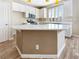Bright, open kitchen with white cabinets, an island with a breakfast bar, and stainless steel appliances at 1001 Collingtree St, Las Vegas, NV 89145