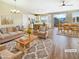 Inviting living room with natural light, neutral tones, and seamless flow to kitchen and dining area at 1001 Collingtree St, Las Vegas, NV 89145