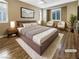 Comfortable primary bedroom with neutral tones, wood floors, and bright windows at 1001 Collingtree St, Las Vegas, NV 89145