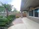 Relaxing backyard, lined with tropical landscaping and a spacious, covered patio at 10227 Sunset Gardens Dr, Las Vegas, NV 89135