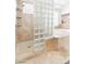 Luxurious primary bathroom with glass block shower and soaking tub at 10227 Sunset Gardens Dr, Las Vegas, NV 89135