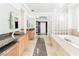 Luxurious primary bathroom featuring dual vanities, tiled floors, and soaking tub at 10227 Sunset Gardens Dr, Las Vegas, NV 89135