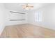 Bright bedroom featuring hardwood floors, ceiling fan, and window with blinds at 10227 Sunset Gardens Dr, Las Vegas, NV 89135