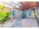 View of the front courtyard with a shade tree, slate walkway and charming shutters at 10227 Sunset Gardens Dr, Las Vegas, NV 89135