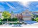 Charming two-story home with landscaped front yard, driveway, and a neutral color palette, perfect for curb appeal at 10227 Sunset Gardens Dr, Las Vegas, NV 89135