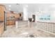 A well-lit kitchen features a center island with stone countertops, custom cabinetry, and stainless steel appliances at 10227 Sunset Gardens Dr, Las Vegas, NV 89135