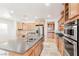 Open kitchen features an island with double sink and seating, with stainless appliances at 10227 Sunset Gardens Dr, Las Vegas, NV 89135