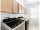 Bright laundry room with washer, dryer, and built-in storage cabinets at 10227 Sunset Gardens Dr, Las Vegas, NV 89135