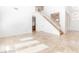 Large living room with natural lighting, tile floors and staircase leading to the second floor of home at 10227 Sunset Gardens Dr, Las Vegas, NV 89135