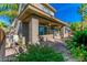 Comfortable covered patio with lush landscaping and a ceiling fan for outdoor living at 10227 Sunset Gardens Dr, Las Vegas, NV 89135