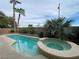 Inviting pool and spa area nestled amongst palm trees, creating a backyard oasis at 10227 Sunset Gardens Dr, Las Vegas, NV 89135