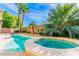 Sparkling pool and hot tub are surrounded by mature landscaping and a sunny blue sky at 10227 Sunset Gardens Dr, Las Vegas, NV 89135