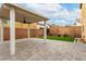 Backyard featuring a covered patio, small grass area, and brick walls for privacy at 10805 Knickerbocker Ave, Las Vegas, NV 89166
