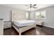 Primary bedroom featuring a decorative headboard, hardwood floors, and a window at 10805 Knickerbocker Ave, Las Vegas, NV 89166