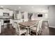 Open-concept dining room with wood floors, modern lighting, and stainless steel appliances at 10805 Knickerbocker Ave, Las Vegas, NV 89166
