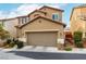 Exterior view of two-story home with desert landscaping and a two-car garage at 10805 Knickerbocker Ave, Las Vegas, NV 89166