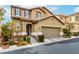 Two-story home exterior featuring a two-car garage, desert landscaping, and covered entryway at 10805 Knickerbocker Ave, Las Vegas, NV 89166