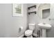 Powder room with a pedestal sink, round mirror and shuttered window at 10805 Knickerbocker Ave, Las Vegas, NV 89166