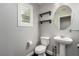 Half bath featuring a modern pedestal sink and a shuttered window at 10805 Knickerbocker Ave, Las Vegas, NV 89166