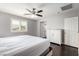 Bright main bedroom featuring hardwood floors, large window, and a white dresser at 10805 Knickerbocker Ave, Las Vegas, NV 89166