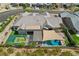 Aerial view of a home with a pool, patio, outdoor kitchen, and basketball court, highlighting an entertainer's backyard at 11181 Luna Blanca Dr, Las Vegas, NV 89138
