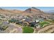 Stunning aerial view of a community clubhouse, pool, and mountain views in the background at 11181 Luna Blanca Dr, Las Vegas, NV 89138