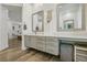 Bright bathroom with dual vanity, modern fixtures, and wood-look flooring at 11181 Luna Blanca Dr, Las Vegas, NV 89138