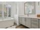 Elegant bathroom showcasing a standalone tub, chandelier, and vanity with marble countertop at 11181 Luna Blanca Dr, Las Vegas, NV 89138