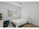 Bright bedroom featuring a modern ceiling fan, hardwood floors, and a chair at 11181 Luna Blanca Dr, Las Vegas, NV 89138