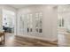 Hallway featuring three shuttered windows, with an office and bathroom visible in the background at 11181 Luna Blanca Dr, Las Vegas, NV 89138