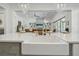 Close-up of kitchen island with seating, a farmhouse sink, and open view into the living area at 11181 Luna Blanca Dr, Las Vegas, NV 89138