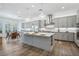 Spacious kitchen with gray cabinets, stainless steel appliances, large island, and an adjacent dining area at 11181 Luna Blanca Dr, Las Vegas, NV 89138