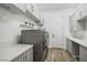 Well-organized laundry room with modern washer and dryer, ample counter space and built-in storage at 11181 Luna Blanca Dr, Las Vegas, NV 89138