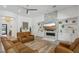 Spacious living room with a stone fireplace, built-in shelves, and stylish leather furniture at 11181 Luna Blanca Dr, Las Vegas, NV 89138