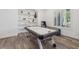 Bright living room area featuring built-in shelves and an air hockey table at 11181 Luna Blanca Dr, Las Vegas, NV 89138