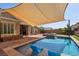 Backyard pool with tanning ledge, waterfall, and privacy landscaping at 11181 Luna Blanca Dr, Las Vegas, NV 89138