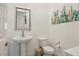 Clean powder room featuring a pedestal sink, toilet, and artwork at 11181 Luna Blanca Dr, Las Vegas, NV 89138