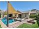 Backyard oasis with a refreshing pool, spa, fire pit, and covered patio for entertaining at 11181 Luna Blanca Dr, Las Vegas, NV 89138